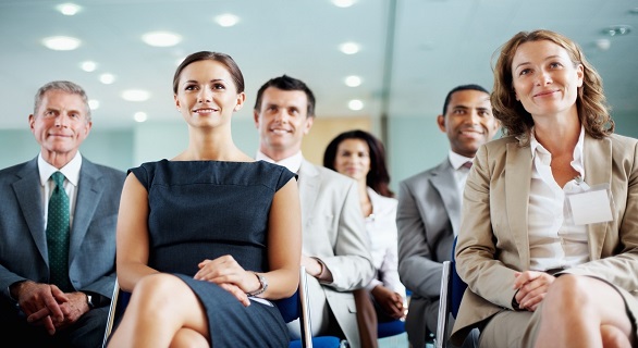 Successful Business Men And Women Sitting In A Conference Room